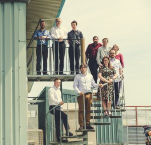 Image shows the piran technologies team standing on an outdoor spiral staircase
